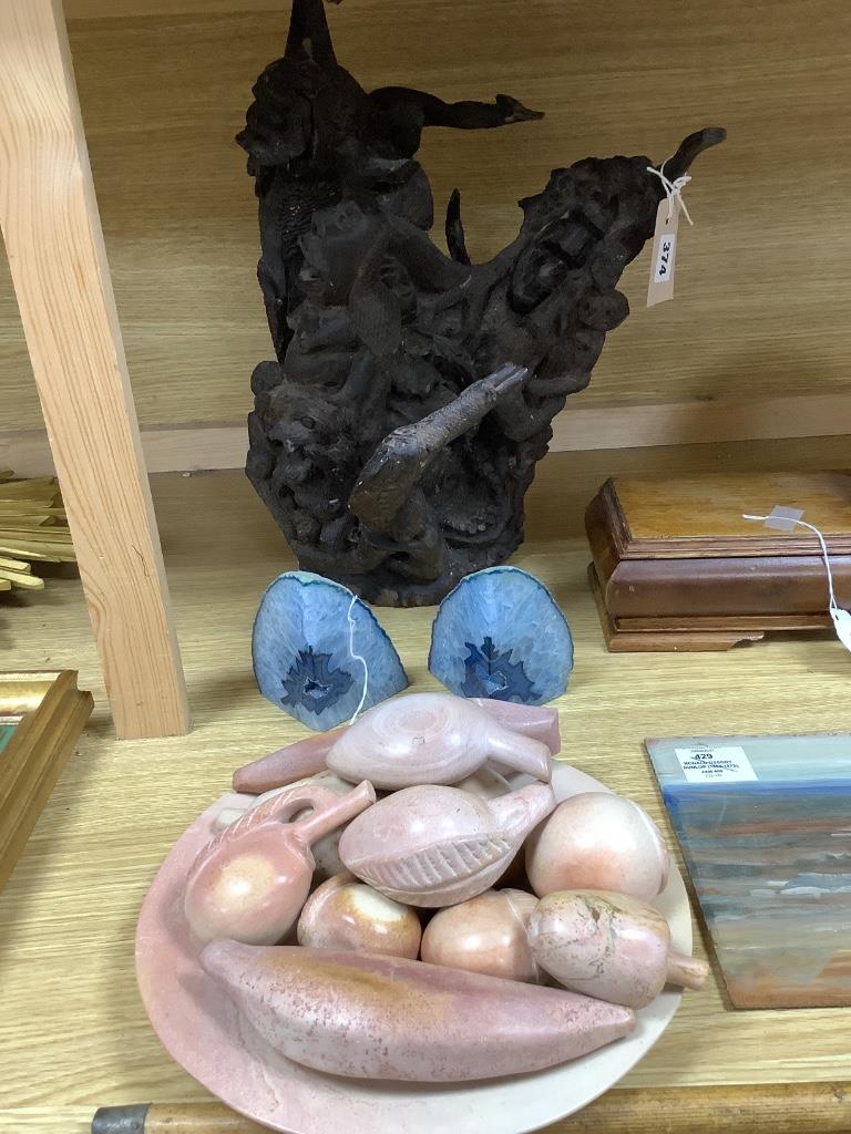 A Kenyan carved hardwood figural group, a collection of carved soapstone fruit, with plate, and a pair of blue agate geode bookends